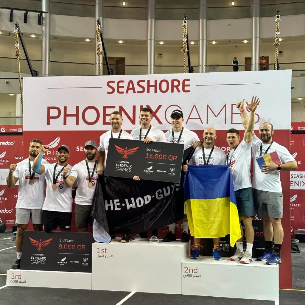 Denis and the FHF team standing proudly on the 1st place podium in Qatar